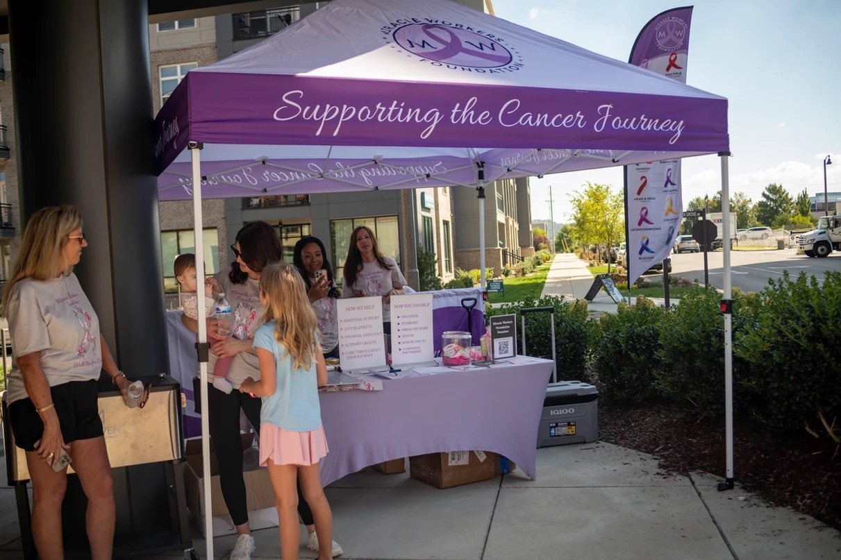 The Miracle Workers Foundation booth with a Supporting the Cancer Journey banner