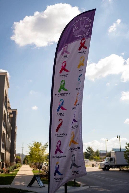 A Miracle Workers Foundation banner displaying cancer awareness ribbons by type and color